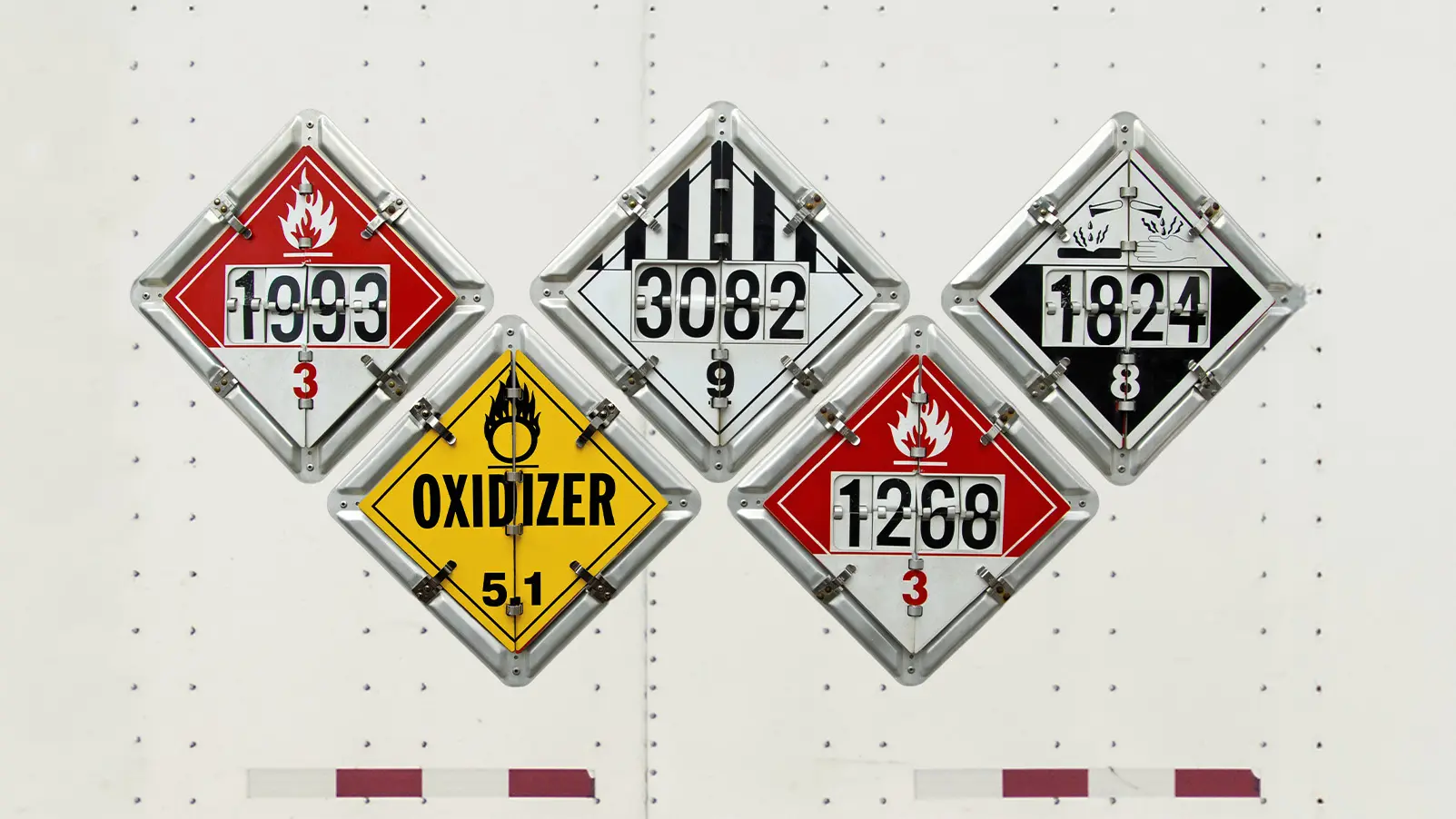 Hazardous materials placards and shipping labels on packaged freight.